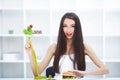Dieting concept, beautiful young woman choosing between healthy Royalty Free Stock Photo