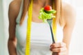 Dieting concept, beautiful young woman choosing between healthy food and junk food Royalty Free Stock Photo