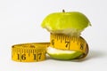 Dieting concept Green apple with measuring tape