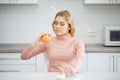 Dieting concept. Young Woman choosing between Fruits and Sweets Royalty Free Stock Photo