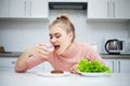 Dieting concept. Young Woman choosing between Fruits and Sweets Royalty Free Stock Photo