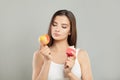 Dieting concept. Young Woman choosing between Fruits and Sweets Royalty Free Stock Photo