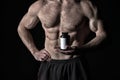 Dieting and fitness. Drug, anabolic, health and medicine. Athletic bodybuilder isolated on black background.