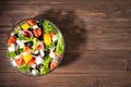 Dieting healthy salad on rustic wooden table top view