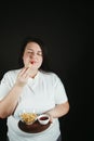 Dieting overweight woman eating french fries