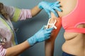 Dietitian doctor taking patient`s body fat measurements on arm with fat caliper