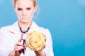Dietitian examine sweet roll bun with stethoscope