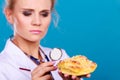 Dietitian examine sweet roll bun with stethoscope