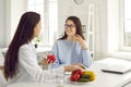 Dietitian giving dieting consultation to young woman who wants to lose some weight