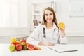 Dietitian nutritionist with fresh orange