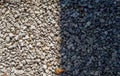 Difference concept. half gravel is in sun and half is shadow. Gravel pattern