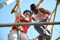 The difference between try and triumph is a little umph. two young men going through an obstacle course at bootcamp.