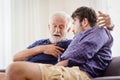 Differences of two generations male elder father with younger man son serious talking consulting together or telling history story Royalty Free Stock Photo
