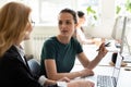 Different age female teammates working together on new project indoors Royalty Free Stock Photo