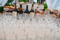 Different alcohol glasses at wedding catering table.