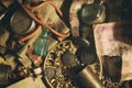 Different antique items on the table: bronze jewelry, old money, retro manometer, magnifier, glass bottle, silverware. Vintage