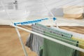 Different apparel drying on clothes airer in bathroom Royalty Free Stock Photo
