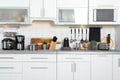 Different appliances, dishes and utensils on kitchen counter