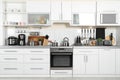 Different appliances, clean dishes on kitchen counter Royalty Free Stock Photo