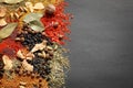 Different aromatic spices on dark background, top view Royalty Free Stock Photo