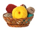 Different balls of woolen knitting yarns in wicker basket on white background Royalty Free Stock Photo