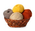 Different balls of woolen knitting yarns in wicker basket on white background Royalty Free Stock Photo