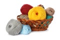 Different balls of woolen knitting yarns in wicker basket on white background Royalty Free Stock Photo