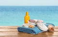 Different beach objects on wooden surface near sea