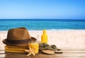 Different beach objects on wooden surface near sea