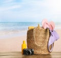 Different beach objects on wooden surface near sea