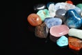 Different beautiful gemstones on black background, closeup. Royalty Free Stock Photo