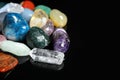 Different beautiful gemstones on black background. Space for text Royalty Free Stock Photo