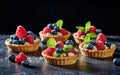 Different berry tarts on light table. Delicious pastries.