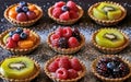 Different berry tarts on light table. Delicious pastries. Royalty Free Stock Photo