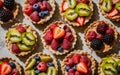 Different berry tarts on light table. Delicious pastries. Royalty Free Stock Photo