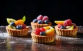 Different berry tarts on light table. Delicious pastries.