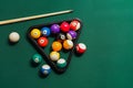 Different billiard balls with cue and rack on green table Royalty Free Stock Photo