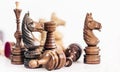 Different black and white wooden chess pieces, horse in the foreground, leadership background Royalty Free Stock Photo