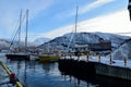 Different boats docket in tromsoe city harbour on a sunny blue day