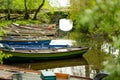 Different boats for rent tied to small pier on Lough Leane, the largest and northernmost of the three lakes of Killarney National