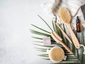 Different body brushes, pumice, bamboo toothbrush, white towel and a piece of soap on a grey background. Zero waste concept. Eco-