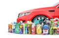 Different Bottles of car maintenance products near red car. Oil, detergents and lubricants. Royalty Free Stock Photo
