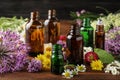 Different bottles of essential oils and flowers