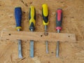 Different brands of chisels on the wall in a small woodworking shop.