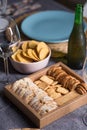 Different bread toast slices on a wooden box on a prepared and served food table on a restaurant Royalty Free Stock Photo