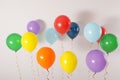 Different bright balloons on light background