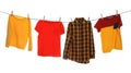 Different bright clothes drying on washing line against white background Royalty Free Stock Photo