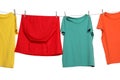 Different bright clothes drying on washing line against white background Royalty Free Stock Photo