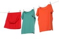 Different bright clothes drying on washing line against white background Royalty Free Stock Photo