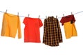 Different bright clothes drying on washing line against white background Royalty Free Stock Photo